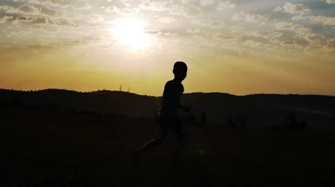 Silhouette of a Boy on a Background of the Sun Dancing Funny Dance Stock Footage 67330209