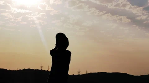 Silhouette of a Boy on the Background of the Sunset Prayer Stock Footage 67263230