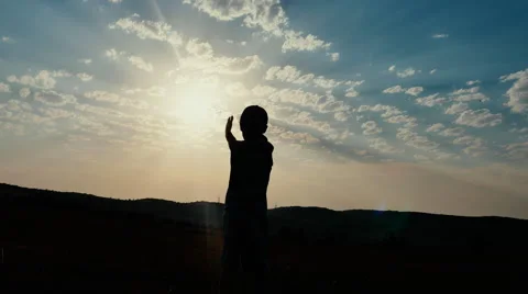 Silhouette of a Boy on the Background of Sunset Shows How Spacious and Stock Footage 67263342