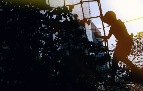 Silhouette of A Boy Climbing on the Rope Stock Photos