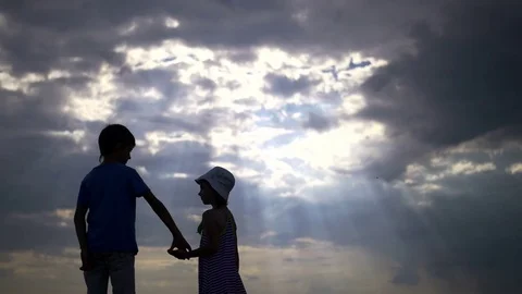 Silhouette Boy With Girl Holding Hands A Stock Video Pond5