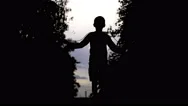 Silhouette Of Boy Jumping Rope Outdoors Stock Footage
