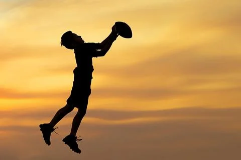 Silhouette of boy playing ball. Stock Photos