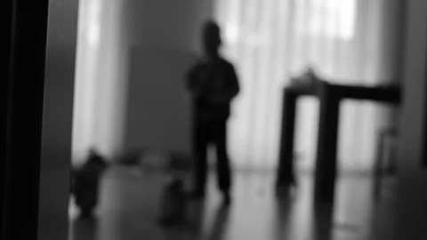 Silhouette of a boy playing in a room Stock Footage 270458406