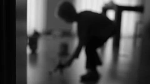 Silhouette of a boy playing in a room Stock Footage 270458407
