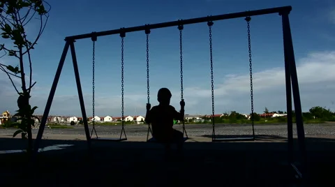 Silhouette boy playing swing alone Stock Footage 65363374