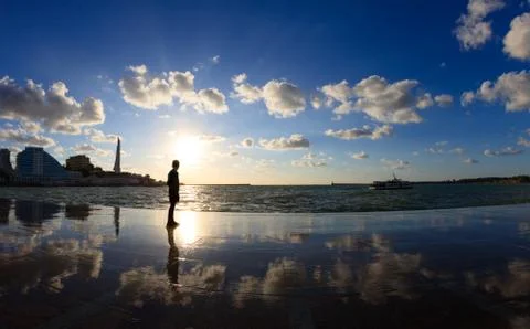 Silhouette of a boy on the seafront Stock Photos