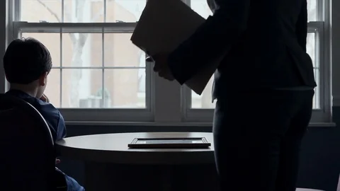 Silhouette of boy sitting in front of window, and woman walks in Stock-Footage 91789611