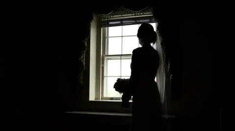 Silhouette of Bride Looking Out Window 動画素材 61349250