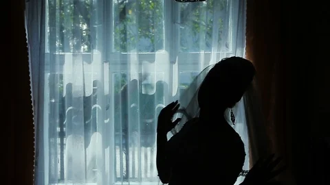 A silhouette of a bride near the window. Stock Footage 96027992