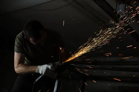 Silhouette of a brutal man engaged in welding. Stock Photos