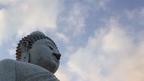 Silhouette of Buddha statue on cloudy background in timelapse Stock Footage 73357310