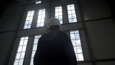 Silhouette builder engineer wear security helmet on background of blue sky Видео 77163286