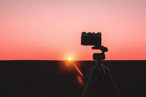 Silhouette of a camera on a tripod Stock Photos