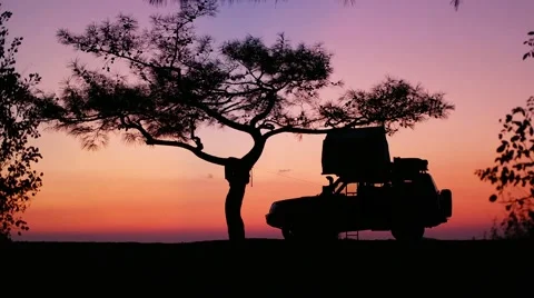 Silhouette of car with mounted tent on the roof at sunrise sunset Video stock 59774545