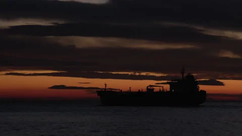 Silhouette of cargo ship going at sunset seascape Video stock 266927950