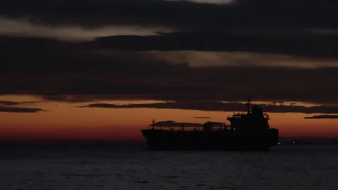 Silhouette of cargo ship going at sunset seascape Stock Footage 267860992