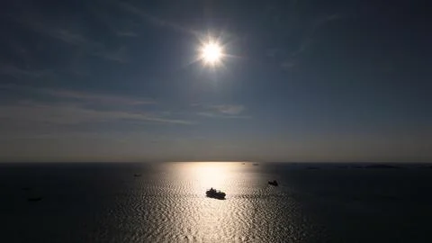 Silhouette Of Cargo Ship Navigating Open Ocean Near Chon Buri Thailand Unde.. Stockfoto's