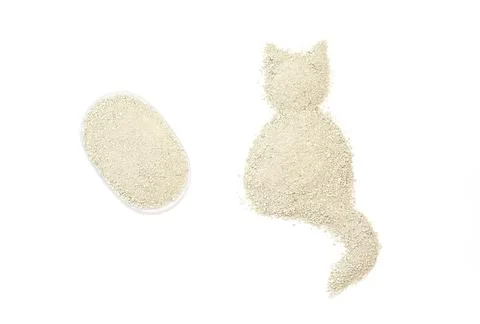 Silhouette of a cat created from fine small granules of cat litter and tran.. Stock Photos