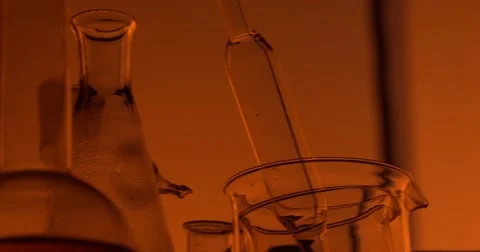Silhouette of the chemist is moving behind the table Video stock 55568173