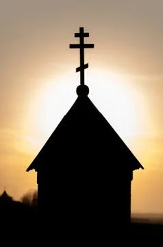 Silhouette of a christian church in sunset Stock Photos