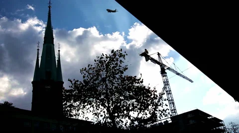 A silhouette church, tree, constructing building, birds, airplane flying in sky Stock Footage 44081677