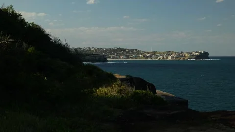 Silhouette cliff top and view of Bondi in distance 6K Stock Footage 306728660