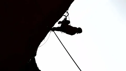 Silhouette of climber on a rock with complex route Stock Footage 71964677