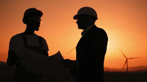 Silhouette Close up face two professionals technicians in hard hat using a large Stock Footage 170659788