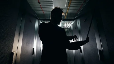 Silhouette of a computer engineer in the server block Video stock 113360025