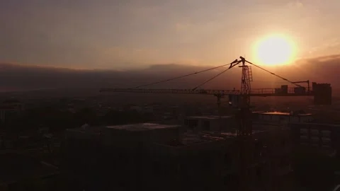 Silhouette of Construction Crane and Unfinished Building at Sunset Stock Footage 343970066