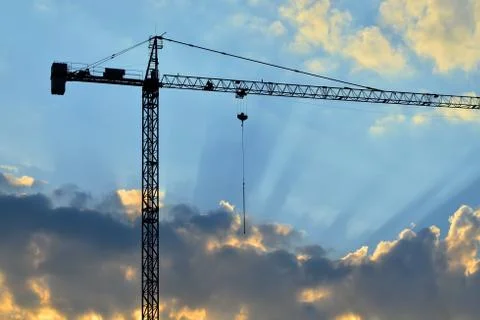 Silhouette of a construction crane Stock Photos