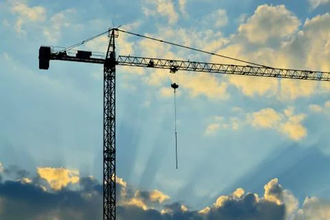 Silhouette of construction crane Stock Photos