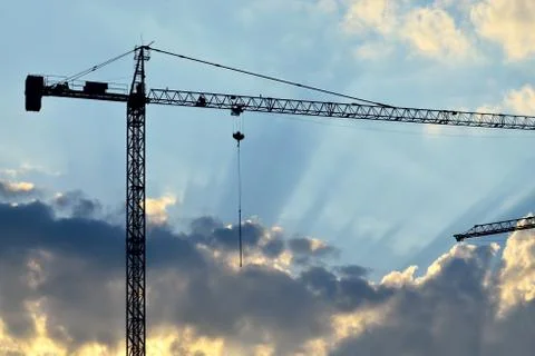Silhouette of construction crane Stock Photos