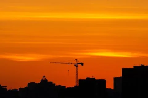 Silhouette of a construction crane Stock Photos