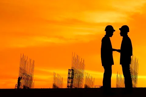 Silhouette construction worker on construction site. Stock Photos