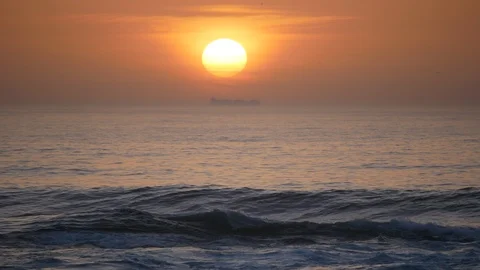 Silhouette container ship passed by setting sun on ocean Stock Footage 95040816