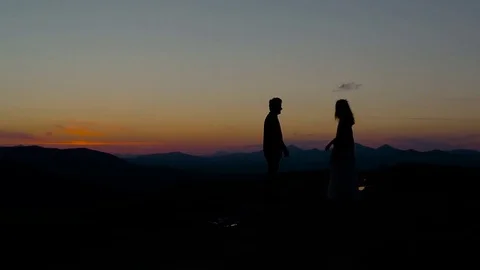 Silhouette of couple on the background of mountains Stock Footage 76249692