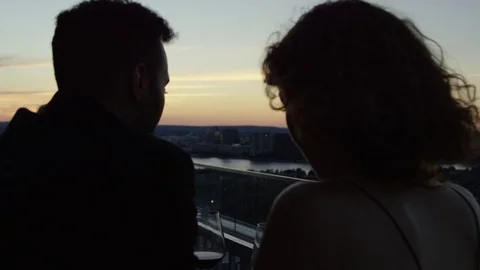 Silhouette Of A Couple On A Date Staring At The Sunset Over The City In Slow Stock Footage 82653553