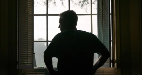 Silhouette of a couple drinking coffee at the window of their home 4k Stock-Footage 95782206