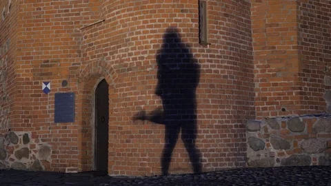 Silhouette of a couple in the shadow actively dancing on a stone wall. Stock Footage 77355822