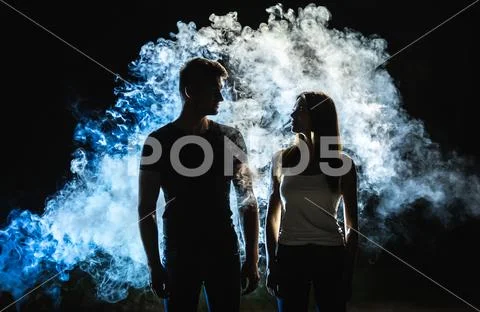 The silhouette of couple in the smoke Stock Photos