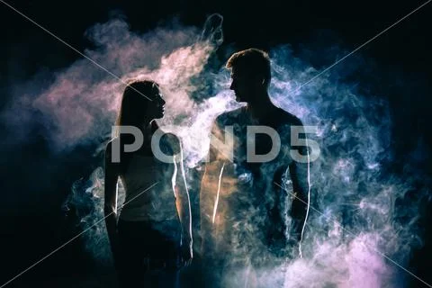 The silhouette of couple in the smoke Stock Photos