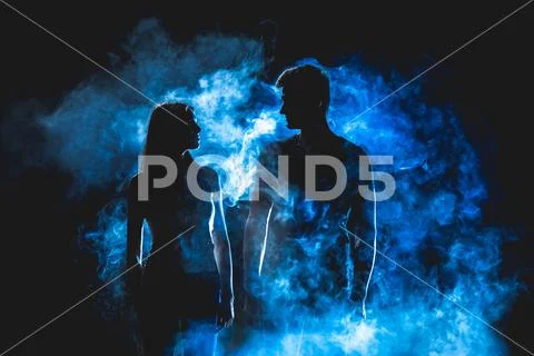 The silhouette of couple in the smoke Stock Photos