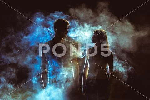 The silhouette of couple in the smoke Stock Photos