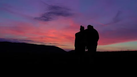 Silhouette Couple standing on a mountain sunset 스톡 동영상 220736879