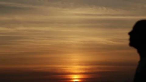 Silhouette of couple at sunset Stock Footage 74827390