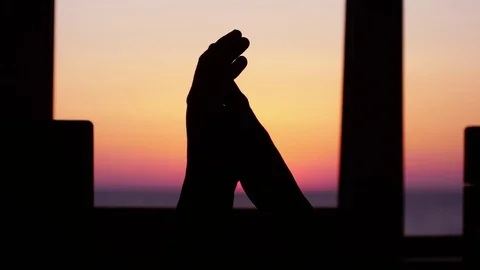 Silhouette of couple's hold hands each other, by the window against the backdrop Stock Footage 85110629