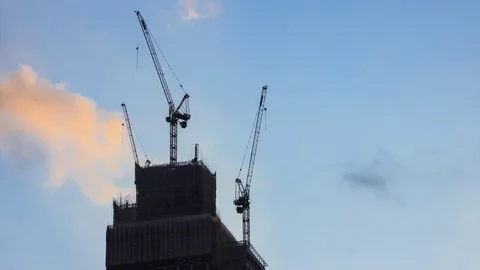 Silhouette Crane On Building Construction Site 4K Time Lapse (zoom out) Stock Footage