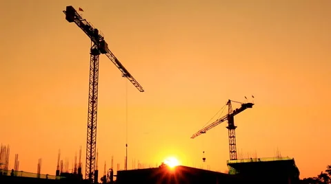 Silhouette crane working in construction site and sunset Stock Footage